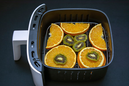 Air fryer with fruits ready to be dehydrated and dried in it.の写真素材
