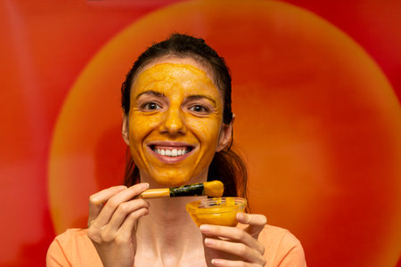Homemade diy face mask made of turmeric, honey and yoghurt for uneven skin tone, brightening dark spots, reducing fine wrinkles lines for diy beautyの写真素材