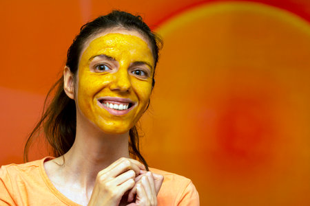 Homemade diy face mask made of turmeric, honey and yoghurt for uneven skin tone, brightening dark spots, reducing fine wrinkles lines for diy beautyの写真素材