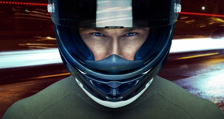 Handsome man in helmet at night in the cityの写真素材