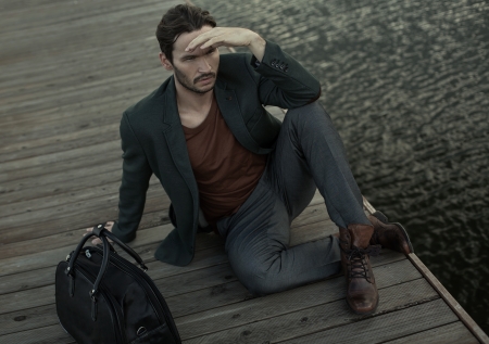 Fashion young man look round and waiting for someoneの写真素材