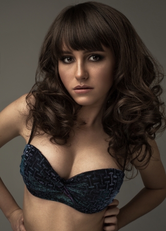 Portrait of brunette girl on grey backgroundの写真素材