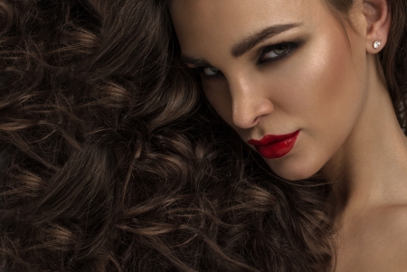 Beauty portrait of woman with hair as backgroundの写真素材