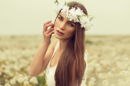 Portrait of young woman on a meadowの写真素材