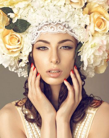 Portrait of young woman with flowersの写真素材
