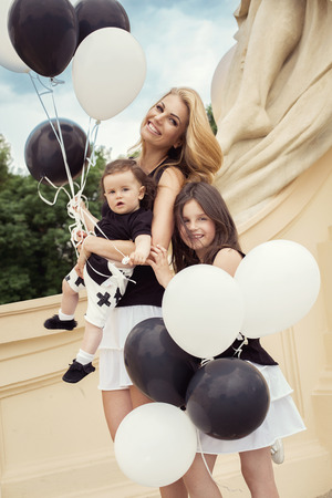 mother with children having a fun with baloonsの写真素材