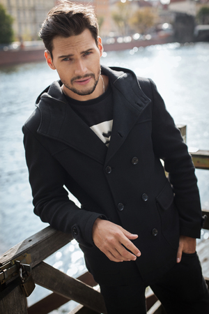 Sexy man in black coatの写真素材