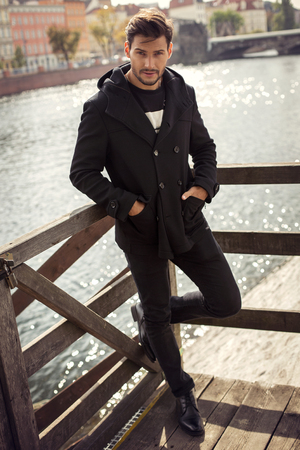 Young model in black coatの写真素材
