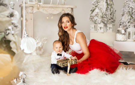 Young mother giving her little boy a Christmas giftの写真素材
