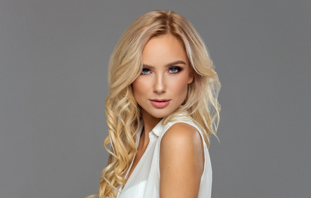 Portrait of blond beauty isolated on grayの写真素材