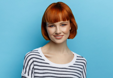 Portrait of beautiful woman with red hairの写真素材