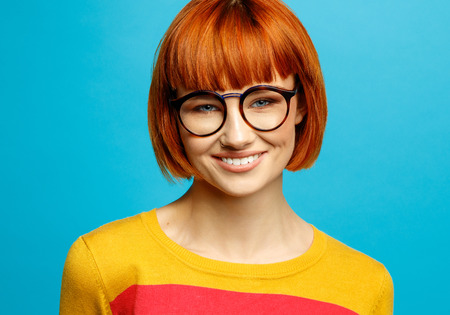Beautiful smiling female model with red hairの写真素材