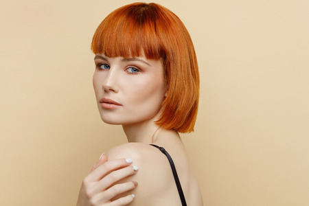 Beauty portrait of female model with red hair and natural skin textureの写真素材