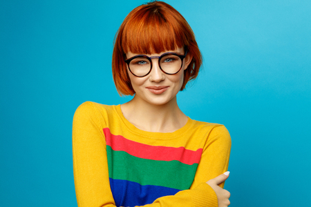 Portrait of beautiful smiling young woman with glassesの写真素材