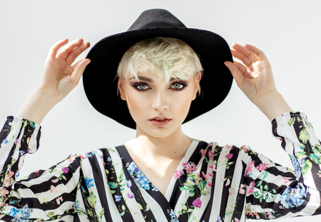 Beauty portrait of fashion blond model in a hatの写真素材