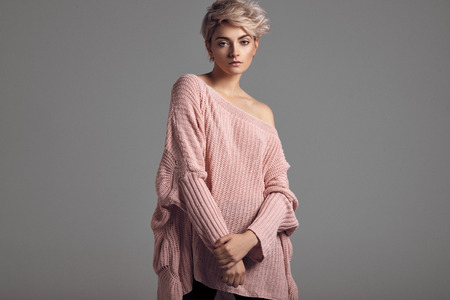 Fashion portrait of female model with blond short hair wear sweaterの写真素材