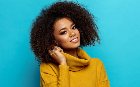 Beautiful african american woman with an afro hairstyle looking at cameraの写真素材