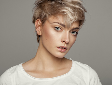 Portrait of fashion trendy haircut girl with copy space isolated on gray backgroundの写真素材