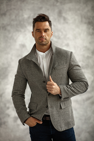 Portrait of handsome man in stylish gray jacketの写真素材