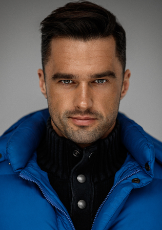 Portrait of handsome man wear blue west and turtleneck jumperの写真素材