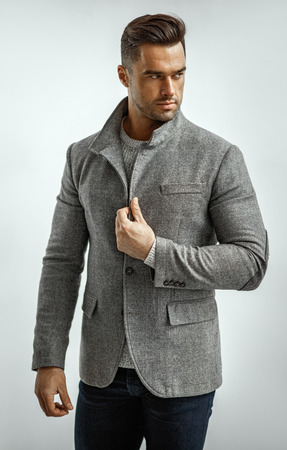 Portrait of handsome man in gray stylish jacket isoalted on white backgroundの写真素材