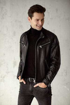 Young handsome man wear black leather jacket and turtleneckの写真素材