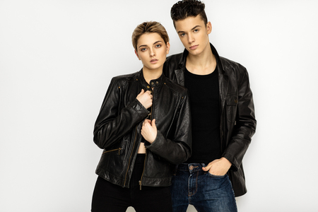 Sexy couple in black leather jacket isolated on white backgroundの写真素材