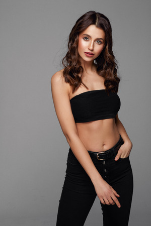 Beautiful brunette woman with big eyes isolated on gray backgroundの写真素材