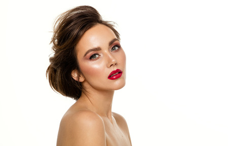 Photo of young attractive woman with fashionable hairdo and red lips isolated on white backgroundの写真素材