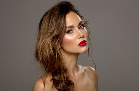Attractive young girl with red lips and messy hairの写真素材