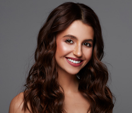 Big beautiful smile of attractive brunete woman with white teeth and big eyesの写真素材