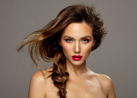 Attractive young girl with red lips and messy hairの写真素材