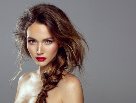 Beauty portrait of female model with braid isolated on gray backgroundの写真素材