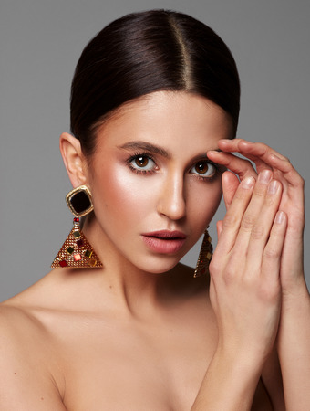 Close up portrait of female face with earringの写真素材