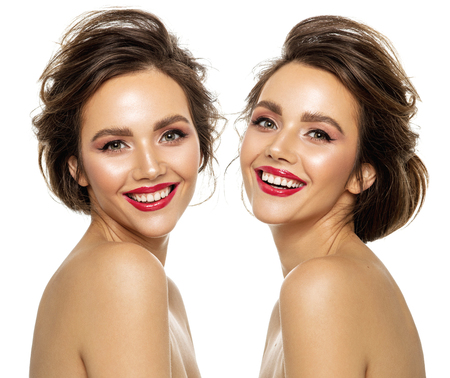 Photo of beautiful smiling twins model with white teeth isolated on white backgroundの写真素材