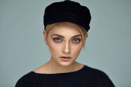 Beauty portrait of fashion young model with black capの写真素材