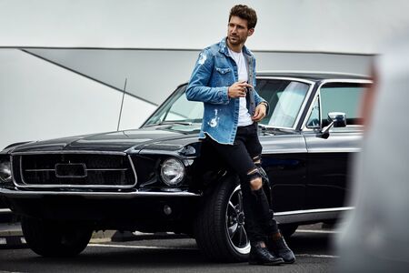 Handsome man with black classic car wear smart casualの写真素材