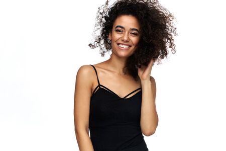 Portrait of beautiful cheerful latin american woman with afro hairstyle looking at camera, isolated on white backgroundの写真素材