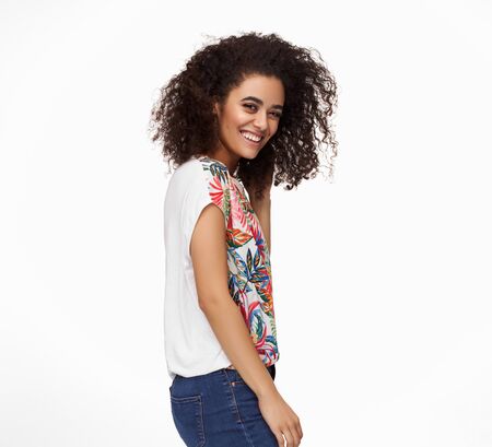 Cheerful latin woman with afro hairstyle isolated on white backgroundの写真素材