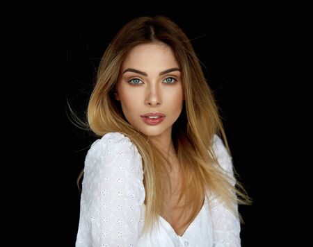 Portrait of sexy blonde woman looking at camera and isolated on black backgroundの写真素材