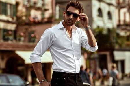 Stylish man wearing sunglasses and white shirtの写真素材