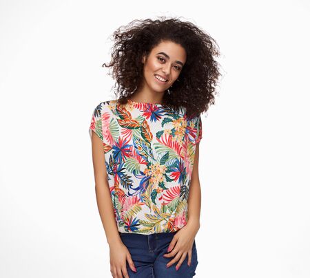 Beautiful cheerful latin woman with afro hairstyle isolated on white backgroundの写真素材