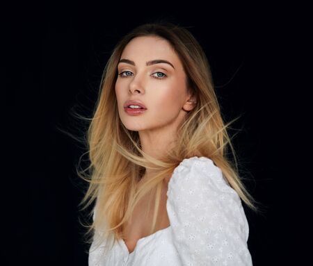 Portrait of sexy blonde woman looking at camera and  isolated on black backgroundの写真素材