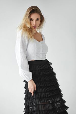 Fashion blonde beautiful girl isolated on gray backgroundの写真素材