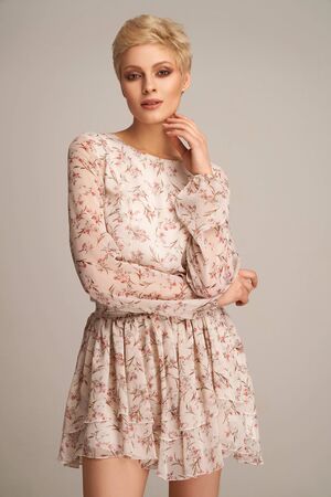 Fashion beautiful elegant woman posing in short summer dressの写真素材