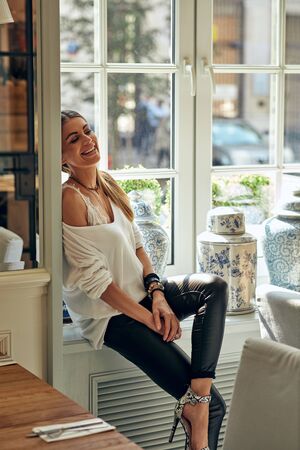 One smiling woman sitting in homeの写真素材