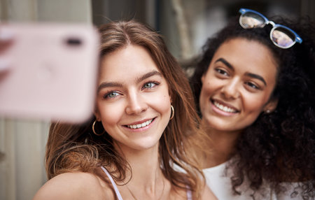 Pretty young girls having fun and taking selfie