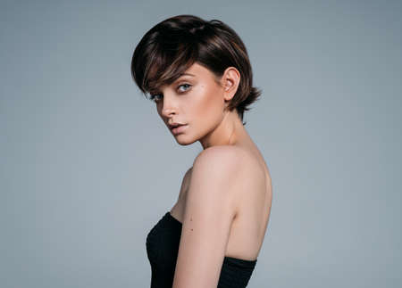 Portrait of a young beautiful brunette girl with stylish short hairの写真素材