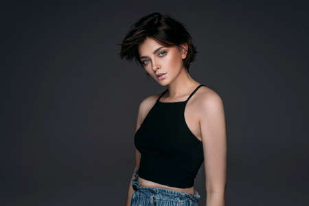 Studio shoot of fashionable brunette woman with short hair looking at cameraの写真素材