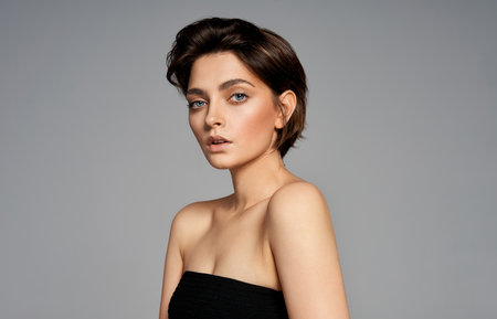 Beautiful portrait of a young beautiful brunette girl with stylish short hairの写真素材